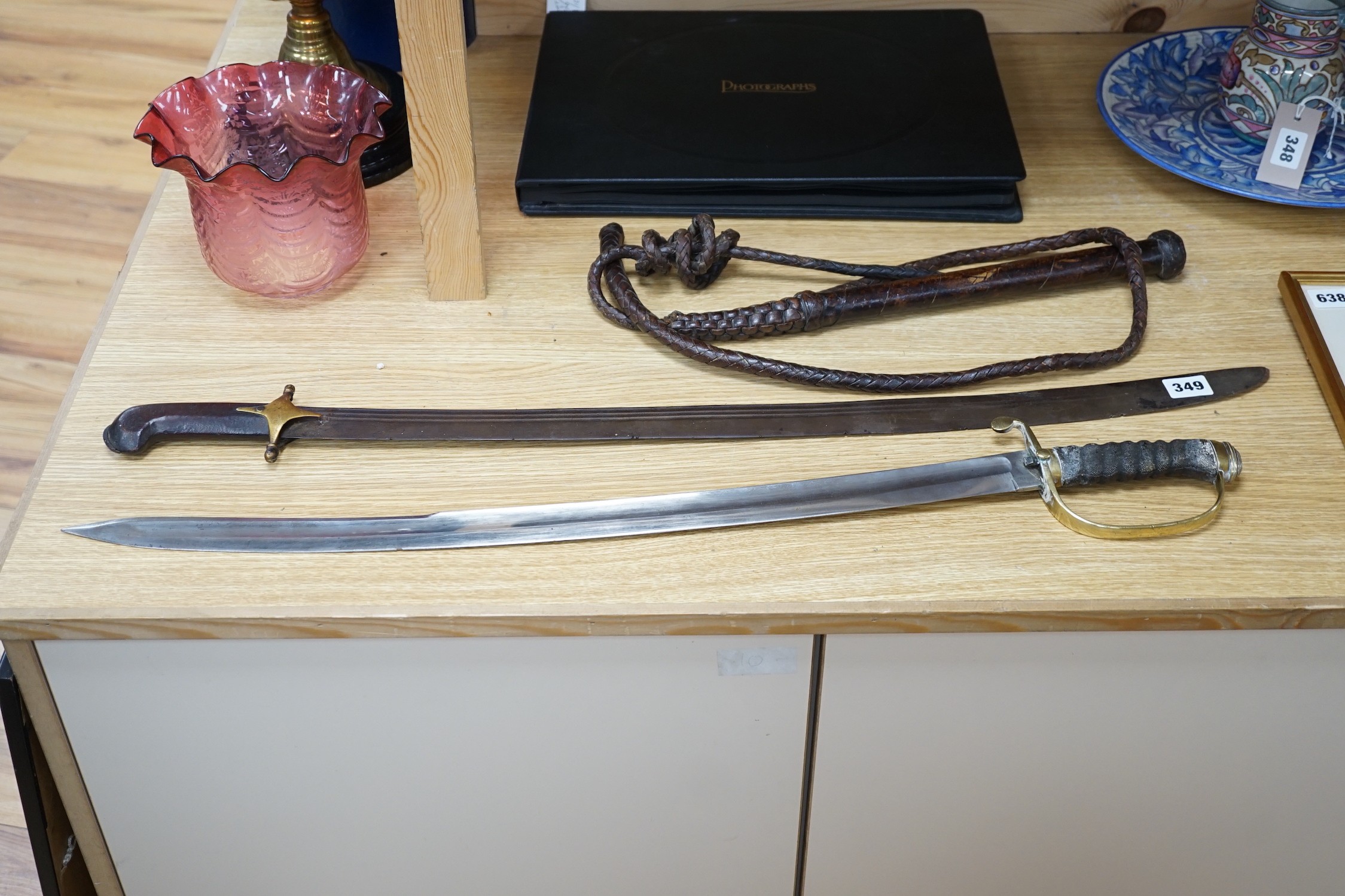 An Ottoman tulwar sabre, a European sabre and a leather whip